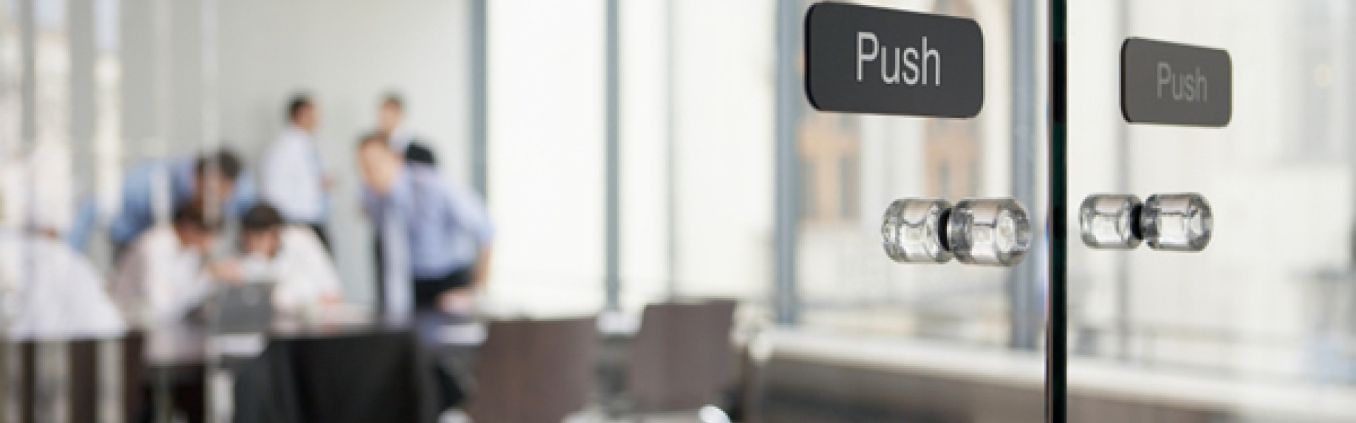 Office meeting behind glass doors