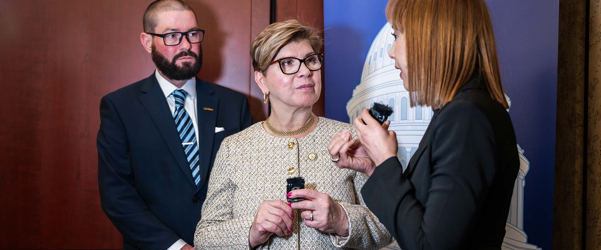 Congresswoman Pou speaking with a reporter